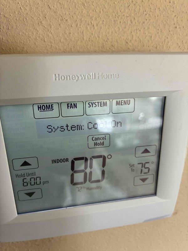 Completed warranty replacement of HVAC control board. Removed failed control board and terminal connector block from equipment housing, installed new replacement control board, and reconnected all electrical wiring including multi-conductor control wiring. Verified proper system operation with thermostat cycling cooling mode correctly, displaying 80°F current temperature with setpoint at 75°F. System restored to normal operation.