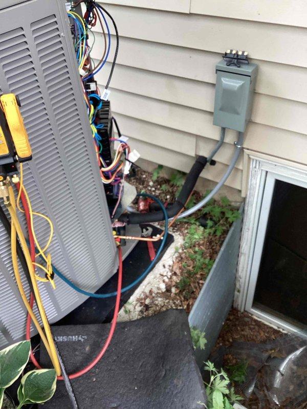 Completed full HVAC system installation including new outdoor condensing unit and indoor evaporator coil. Installed air conditioning unit on vibration-dampening pad with proper electrical disconnect box and conduit mounted to exterior wall. Ran refrigerant lines from outdoor unit to indoor coil located in basement mechanical room. Mounted evaporator coil with supply and return ductwork connections, ensuring proper airflow configuration. Utilized manifold gauges to charge system with refrigerant to manufacturer specifications and verified proper pressures. All electrical connections completed by licensed electrician. Installation performed with required permits and inspections. System tested for proper operation, refrigerant levels confirmed, and unit left in full working order.