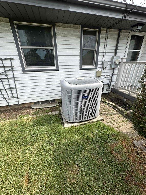 Evaluated existing 15+ year old heat pump system with failed compressor located at residential property. Unit showed signs of age-related deterioration and compressor failure, making repair economically unfeasible. Exterior condensing unit and indoor air handler assessed for replacement specifications. Documented existing installation including electrical disconnect, conduit routing, and concrete pad placement. Interior mechanical room inspection revealed moisture concerns on concrete floor, indicating potential condensate drainage issues requiring attention during replacement. Provided comprehensive replacement estimate for complete heat pump system to restore heating and cooling functionality to the residence.