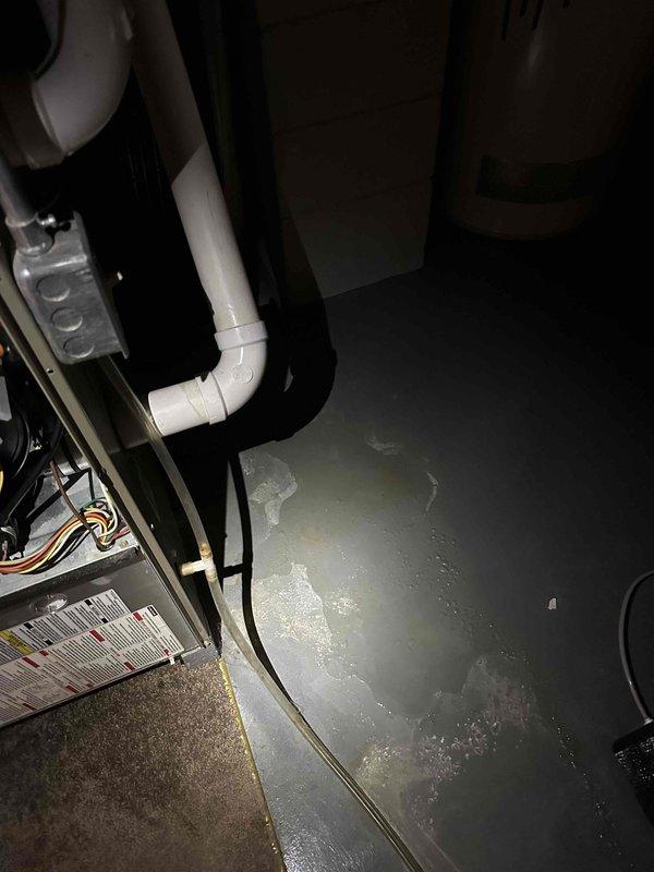 Evaluated existing 15+ year old heat pump system with failed compressor located at residential property. Unit showed signs of age-related deterioration and compressor failure, making repair economically unfeasible. Exterior condensing unit and indoor air handler assessed for replacement specifications. Documented existing installation including electrical disconnect, conduit routing, and concrete pad placement. Interior mechanical room inspection revealed moisture concerns on concrete floor, indicating potential condensate drainage issues requiring attention during replacement. Provided comprehensive replacement estimate for complete heat pump system to restore heating and cooling functionality to the residence.
