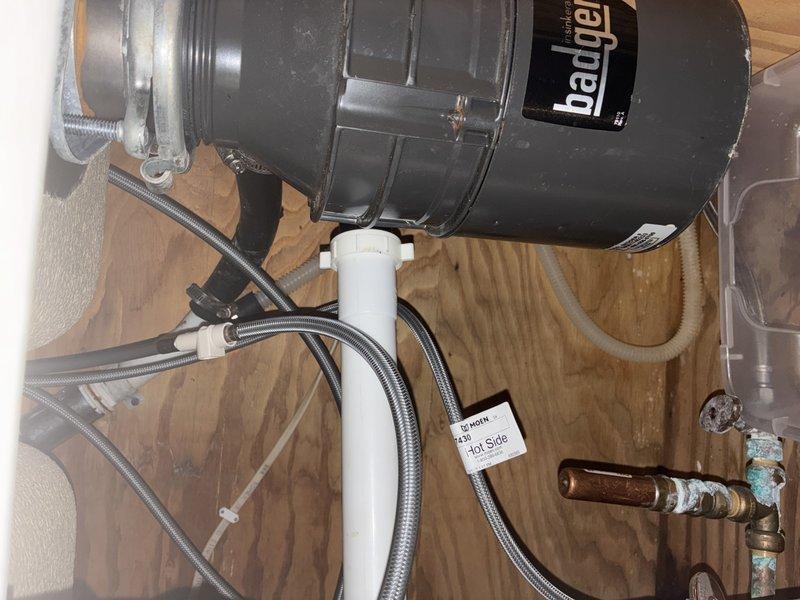 Responded to service call for non-functional garbage disposal unit. Successfully removed existing Badger brand disposal unit from under kitchen sink and disconnected all associated plumbing connections including drain lines and electrical supply. Installed new standard drain basket assembly with proper strainer and tailpiece to replace disposal system. Reconfigured under-sink plumbing using existing PVC drain piping, ensuring proper trap configuration and secure connections. Tested drain system for proper flow and verified no leaks at all connection points.