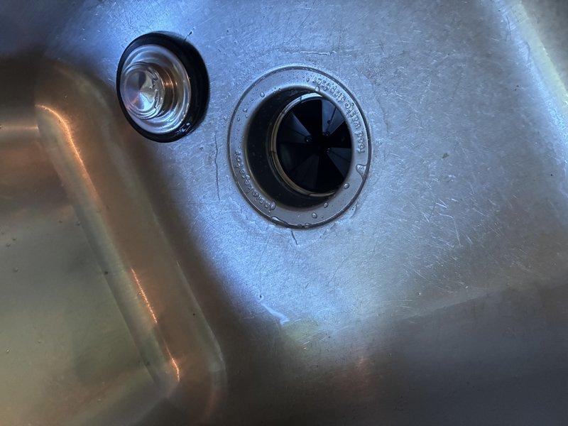Responded to service call for non-functional garbage disposal unit. Successfully removed existing Badger brand disposal unit from under kitchen sink and disconnected all associated plumbing connections including drain lines and electrical supply. Installed new standard drain basket assembly with proper strainer and tailpiece to replace disposal system. Reconfigured under-sink plumbing using existing PVC drain piping, ensuring proper trap configuration and secure connections. Tested drain system for proper flow and verified no leaks at all connection points.