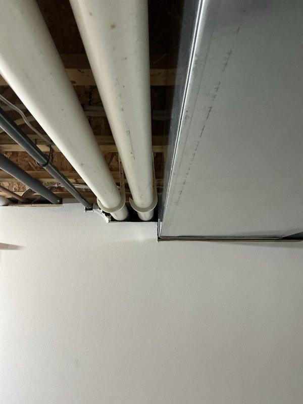Completed estimate for full HVAC system replacement in residential basement installation. Existing Lennox furnace and air conditioning system evaluated due to AC unit experiencing intermittent lockout issues. Assessed current equipment configuration including sheet metal plenum, ductwork connections, and PVC condensate drainage lines. Documented existing installation layout with furnace positioned on concrete floor, vertical supply plenum, and associated mechanical components. Provided comprehensive replacement options to address reliability concerns with current system experiencing random AC lockouts.