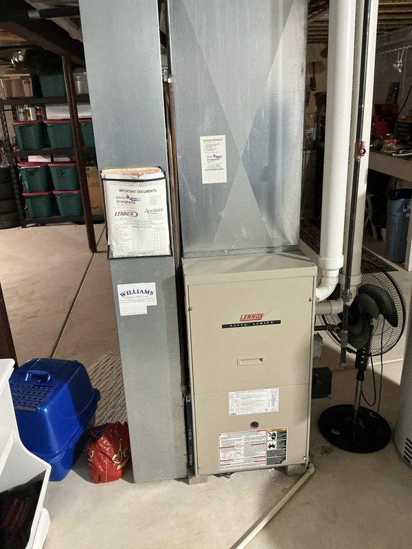 Completed estimate for full HVAC system replacement in residential basement installation. Existing Lennox furnace and air conditioning system evaluated due to AC unit experiencing intermittent lockout issues. Assessed current equipment configuration including sheet metal plenum, ductwork connections, and PVC condensate drainage lines. Documented existing installation layout with furnace positioned on concrete floor, vertical supply plenum, and associated mechanical components. Provided comprehensive replacement options to address reliability concerns with current system experiencing random AC lockouts.