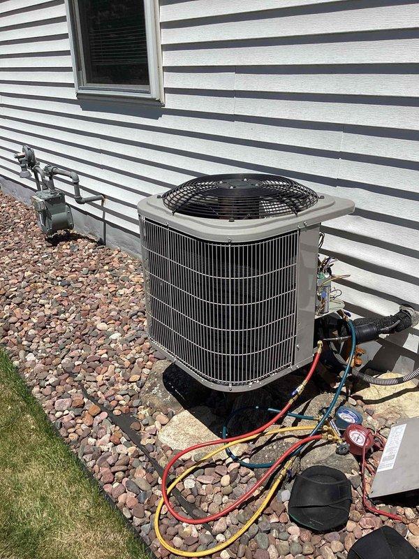 Responded to no cooling call on 10+ year old residential air conditioning system with recurring breaker trip issue. Previous capacitor replacement had provided temporary relief, but compressor was drawing excessive amperage and tripping breaker upon startup. Connected manifold gauges and performed diagnostic testing, which revealed compressor motor windings had shorted internally, causing high amp draw beyond breaker rating. Verified compressor was locked and confirmed system was non-repairable due to age and extent of failure. Disconnected power at outdoor disconnect and breaker panel to prevent further electrical hazards. Recommended complete system replacement due to unit age and failed compressor, as repair costs would not be economical on equipment of this vintage.