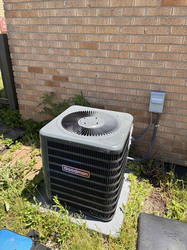 Responded to no cooling complaint on Goodman brand air conditioning system. Upon arrival, found unit experiencing refrigerant issue with evaporator coil temperature reading 57.0°F, indicating inadequate cooling performance. Additionally, identified active water leak at condensate drain fitting requiring immediate attention. Addressed drainage issue and assessed system performance. Unit is over 10 years old and showing age-related wear on outdoor condenser components.