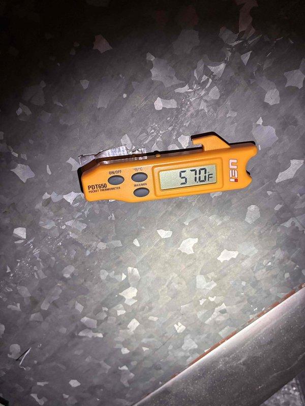 Responded to no cooling complaint on Goodman brand air conditioning system. Upon arrival, found unit experiencing refrigerant issue with evaporator coil temperature reading 57.0°F, indicating inadequate cooling performance. Additionally, identified active water leak at condensate drain fitting requiring immediate attention. Addressed drainage issue and assessed system performance. Unit is over 10 years old and showing age-related wear on outdoor condenser components.
