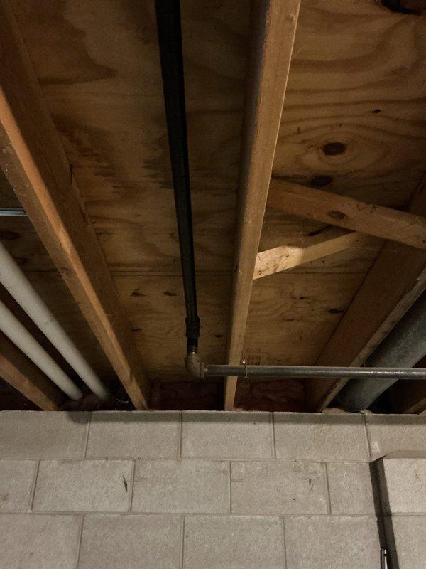 Conducted diagnostic inspection for conversion from electric to gas appliances, including stove, dryer, and water heater. Assessed existing basement infrastructure and kitchen layout to determine gas line routing requirements. Documented current electrical stove configuration and basement ceiling space where new gas lines will be installed, identifying optimal path through exposed joists alongside existing plumbing for future gas service connections.