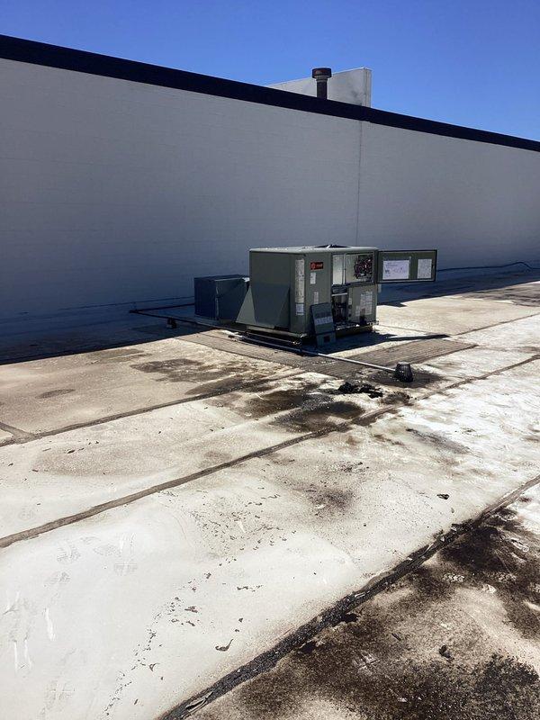 Completed commercial rooftop unit installation on flat membrane roof. Coordinated equipment delivery and crane service for proper placement of new RTU alongside existing rooftop HVAC equipment. Unit positioned on raised curb, with all rigging, electrical connections, and startup procedures executed per manufacturer specifications.
