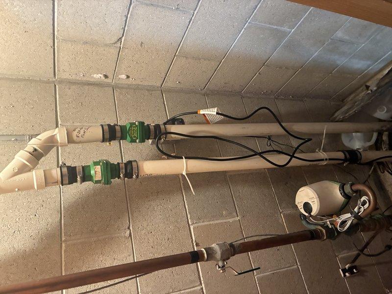 Conducted on-site evaluation of existing sump pump system and water softener installation for potential replacement. Assessed current sump pump configuration and determined requirements for upgraded system with integrated battery backup capability. Inspected existing plumbing infrastructure including overhead PVC piping with valve assemblies and discharge lines to ensure compatibility with proposed equipment upgrade. Evaluated 2005 water softener unit condition and operational status. Documented existing installation layout including pipe routing, electrical connections, and valve placements to develop comprehensive replacement estimate for both sump pump with battery backup system and water softener unit.