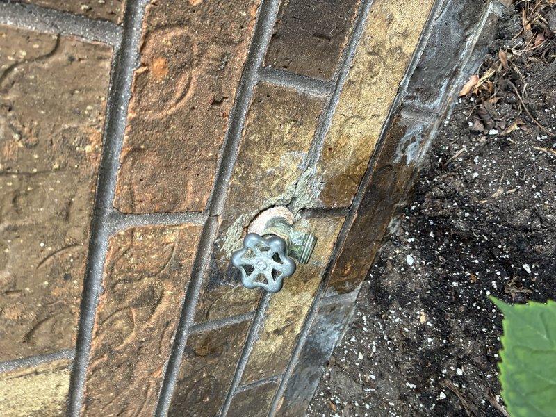 Replaced a 40-year-old exterior hose bib that had reached the end of its service life due to extensive weathering and corrosion. Removed the deteriorated spigot with oxidized star-handle valve from the brick exterior wall, installed new frost-proof sillcock with shutoff valve accessible from interior basement location, and secured all copper supply lines with proper mounting brackets to concrete block foundation wall. All connections were tested and verified leak-free upon completion.