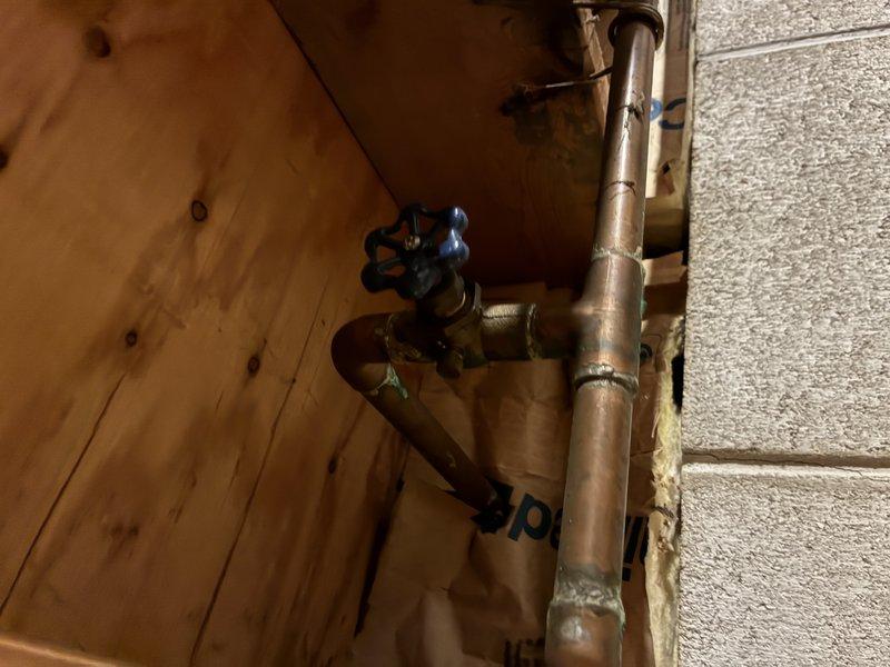 Replaced a 40-year-old exterior hose bib that had reached the end of its service life due to extensive weathering and corrosion. Removed the deteriorated spigot with oxidized star-handle valve from the brick exterior wall, installed new frost-proof sillcock with shutoff valve accessible from interior basement location, and secured all copper supply lines with proper mounting brackets to concrete block foundation wall. All connections were tested and verified leak-free upon completion.