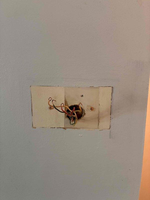 Responded to no cooling call with blank thermostat display. Found Honeywell thermostat showing low battery warning despite customer replacing batteries. Diagnosed failed thermostat unit, removed old device from wall, exposed and prepared wiring connections, and installed replacement thermostat to restore system operation and cooling functionality.