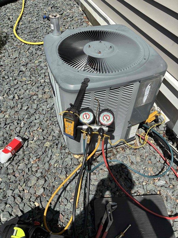 # HVAC Service Report

Responded to no cooling complaint on residential air conditioning system. Upon arrival, found outdoor condenser unit operational but system not providing adequate cooling to structure. Connected manifold gauge set to service ports and performed refrigerant pressure diagnostics. Measured system pressures on both high and low sides to determine operating conditions. Utilized digital testing equipment to assess electrical components and system performance parameters.

Based on diagnostic findings, system showed signs of refrigerant-related issues affecting cooling capacity. Given the age of the unit (10+ years), evaluated overall system condition including condenser coil, fan operation, and refrigerant line integrity. Discussed findings and available options with customer regarding repair versus replacement considerations for aging equipment. System requires further service to restore proper cooling function.