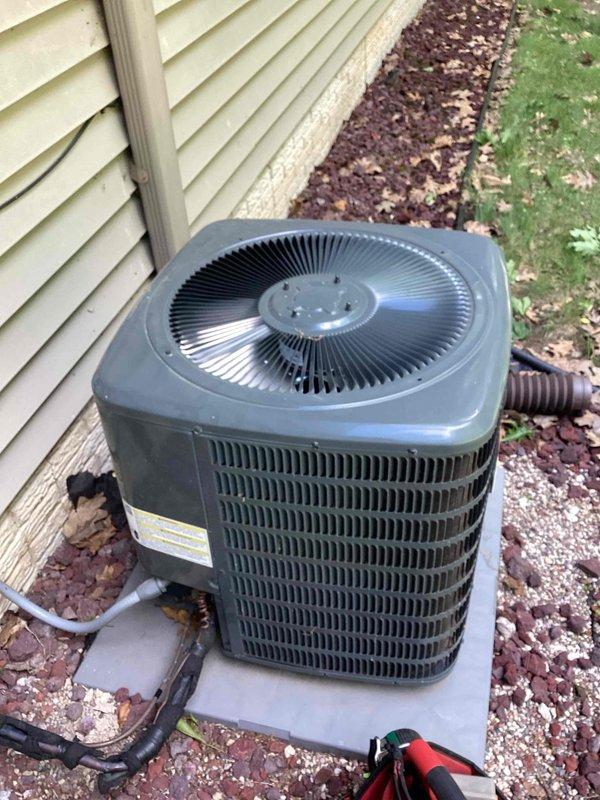 Responded to no cooling complaint on residential split system with air handler located in attic. Upon arrival, found thermostat inoperative and system previously shut down. Connected manifold gauges to outdoor condensing unit to verify system pressures and diagnose cooling failure. Determined thermostat malfunction was preventing system operation and addressed issue to restore normal cooling function.