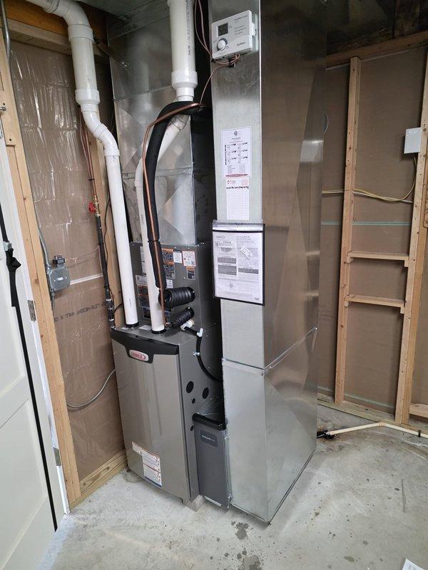 Completed full HVAC system installation in residential utility room, including new furnace and air conditioning unit with proper refrigerant line connections, electrical conduit, and PVC condensate drainage. All work performed with required permits and licensed electrician on-site, system tested and operational upon completion.