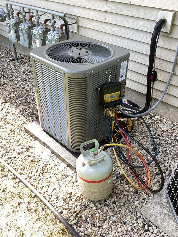 Completed full HVAC system replacement including new furnace and air conditioning condenser unit. Installed outdoor AC unit on concrete pad with proper refrigerant line connections running along exterior wall, performed refrigerant charging and system diagnostics using manifold gauges to verify proper operation. Indoor furnace unit installed in basement utility area with all necessary electrical connections completed and system fully tested for proper heating and cooling functionality.