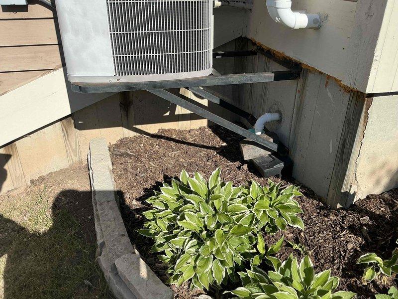 Conducted comprehensive estimate for replacement of 25-year-old natural gas furnace and air conditioning system, both currently operational but nearing end of service life. Evaluated existing exterior AC condenser unit mounted on elevated platform with weathered support structure, and basement-located NG furnace with walk-out access via sliding doors. Discussed available promotions, zoning options for basement climate control, and dehumidification system integration to address moisture management needs.