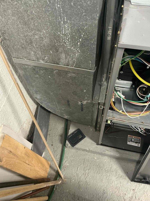 Conducted estimate for complete air conditioning system replacement due to refrigerant leak and freeze-up condition on 17-year-old unit. Assessed existing natural gas furnace in basement and documented current HVAC equipment configuration, including air handler with foil-wrapped ductwork and electrical connections, to provide comprehensive replacement recommendations for aging system that has reached end of serviceable life.