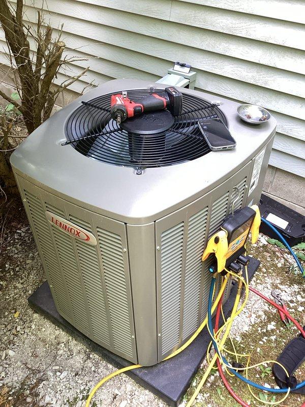 Responded to no cooling complaint on residential split system. Upon arrival, connected manifold gauges to outdoor Lennox condenser unit to verify system pressures and diagnose cooling issue. Customer suspected thermostat malfunction; performed diagnostic testing to determine root cause. System evaluation included pressure readings and operational assessment of both indoor furnace/air handler and outdoor condensing unit to identify failure point and restore cooling functionality.