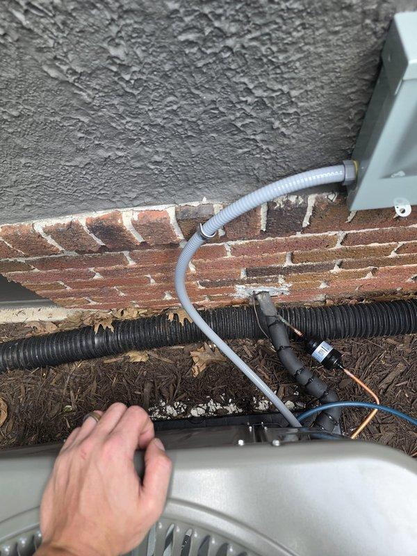 Completed full HVAC system installation including new air conditioning condenser unit and evaporator coil. Installed furnace unit in basement on concrete pad with proper ductwork transitions and copper refrigerant line connections routed overhead. Mounted outdoor condenser unit against exterior brick wall with refrigerant lines, electrical wiring, and condensate drainage properly secured using wall-mounted brackets. All electrical connections completed and system commissioned for operation. Installation performed without permit requirements per customer specifications, with electrical work handled by licensed electrician.