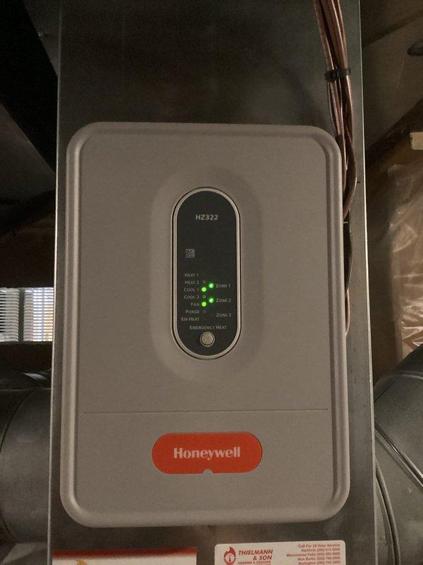 Replaced zone damper actuator for Zone 11-2 in multi-zone HVAC system. Verified proper operation of Honeywell HZ322 zone control panel with both zones responding correctly to thermostat calls. Confirmed damper motor functionality and system cycling through heating and cooling modes as designed.