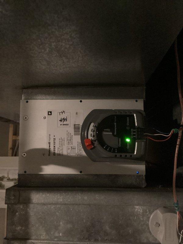 Replaced zone damper actuator for Zone 11-2 in multi-zone HVAC system. Verified proper operation of Honeywell HZ322 zone control panel with both zones responding correctly to thermostat calls. Confirmed damper motor functionality and system cycling through heating and cooling modes as designed.