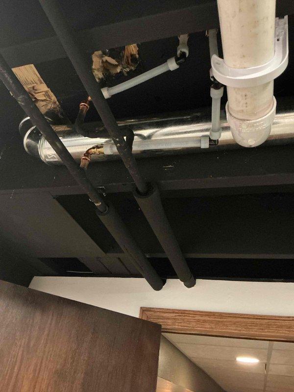 Relocated laundry connections and dryer vent per estimate specifications. Successfully rerouted white PVC drain lines and water supply piping through wall cavities and ceiling joists, securing all pipes with appropriate mounting brackets and straps to structural framing. Modified copper supply lines and installed new junction boxes to accommodate the repositioned laundry equipment location.