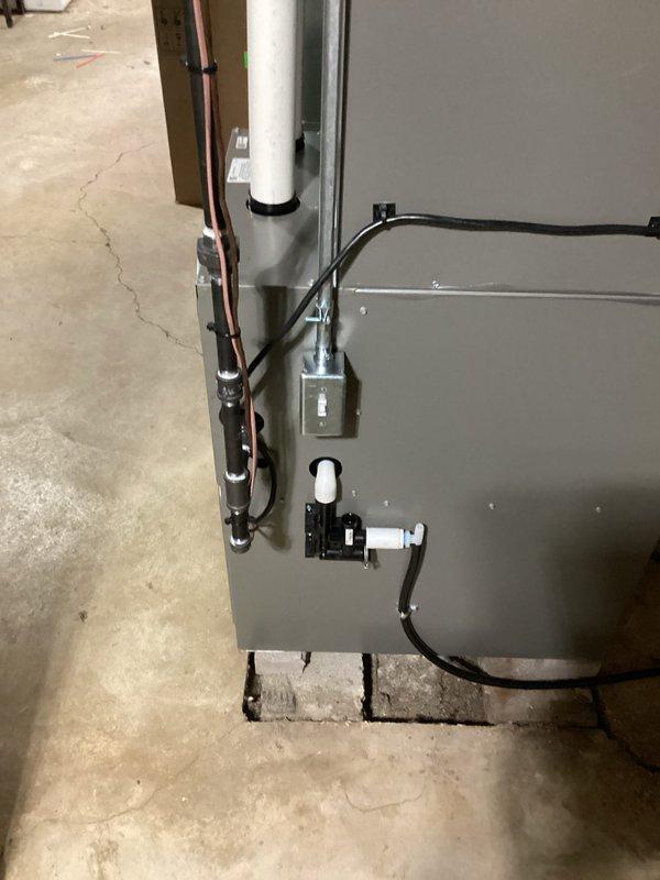 Completed full HVAC system installation including new air conditioning condenser unit and air handler. The outdoor condenser unit was positioned on a base pad against the building exterior with proper clearances maintained, refrigerant lines connected, and electrical service established. Inside, installed the air handler on elevated supports with all refrigerant lines properly insulated and secured, PVC condensate drain lines routed and terminated correctly, and electrical connections completed to code. System was pressure tested, evacuated, charged with refrigerant to manufacturer specifications, and fully commissioned with all operational parameters verified within normal range.