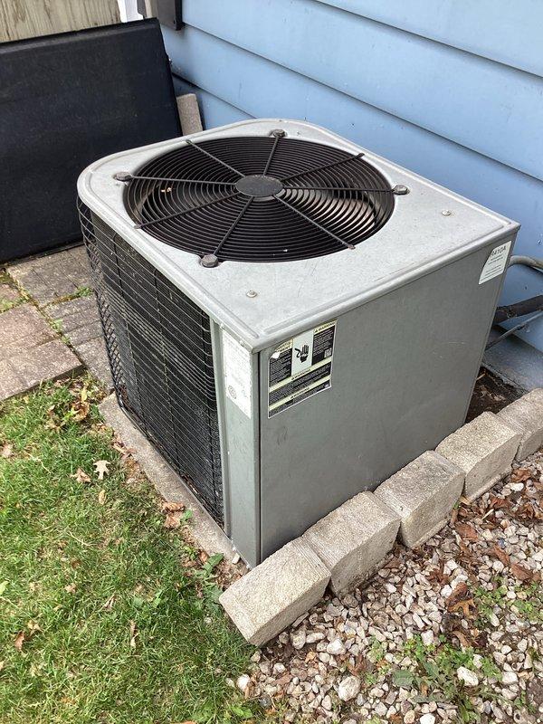 Responded to no cooling complaint on residential air conditioning system with furnace recently installed five months prior. Performed diagnostic evaluation of outdoor condensing unit and associated components. Unit appeared in good physical condition with proper installation on concrete pad and adequate clearance from building structure. Verified electrical disconnect box present and accessible for service. System evaluated for potential refrigerant issues, electrical faults, or thermostat communication problems common in newly installed split systems where cooling season activation occurs after initial heating-only operation period.