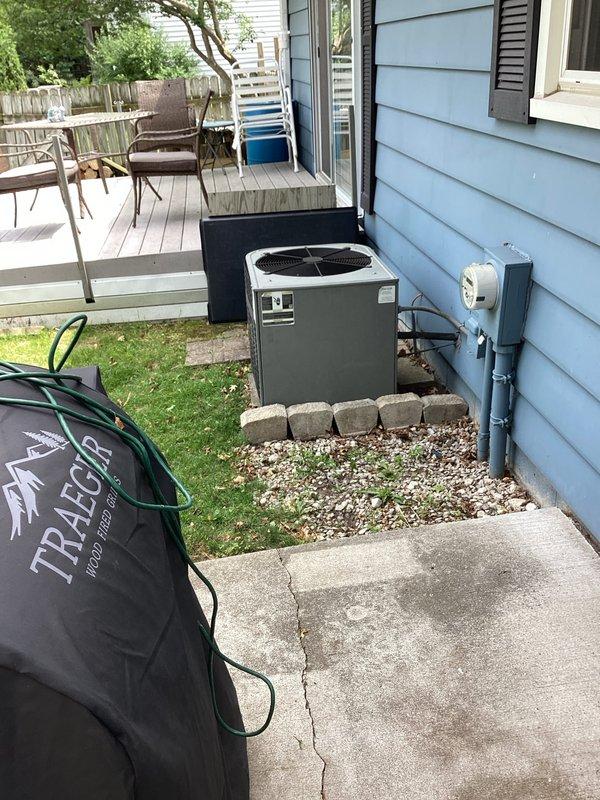 Responded to no cooling complaint on residential air conditioning system with furnace recently installed five months prior. Performed diagnostic evaluation of outdoor condensing unit and associated components. Unit appeared in good physical condition with proper installation on concrete pad and adequate clearance from building structure. Verified electrical disconnect box present and accessible for service. System evaluated for potential refrigerant issues, electrical faults, or thermostat communication problems common in newly installed split systems where cooling season activation occurs after initial heating-only operation period.