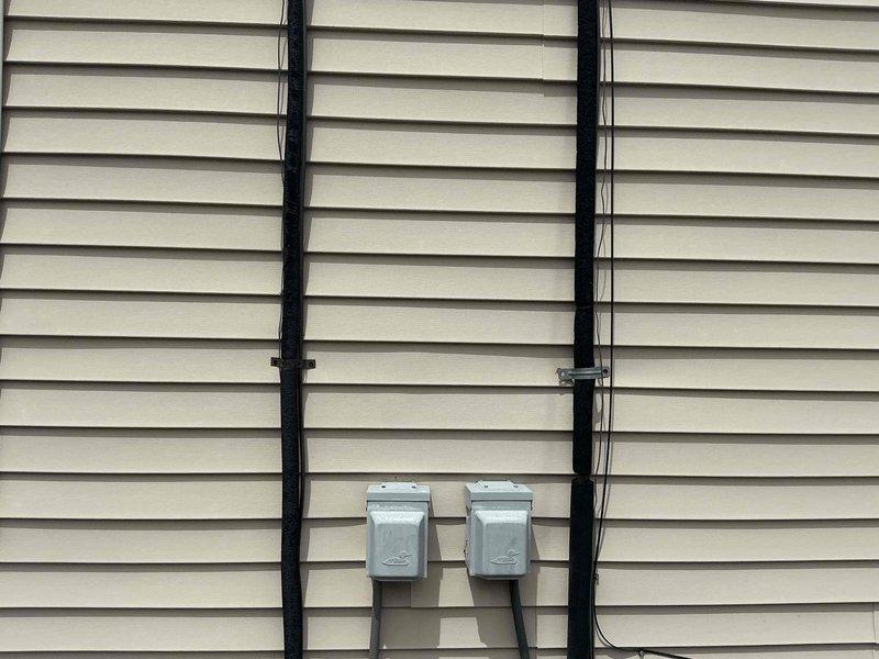 Performed comprehensive assessment of two non-operational air conditioning systems and evaluated existing furnace units to determine replacement requirements. Inspected exterior condenser units, electrical disconnects, and refrigerant line sets mounted on building exterior. Evaluated interior equipment including furnace located in closet and second furnace in laundry room, both installed without basement access. Documented existing HVAC infrastructure including ductwork, condensate drainage systems, and electrical connections. Prepared replacement estimates for dual AC systems and provided professional recommendation regarding furnace replacement needs based on equipment condition and system compatibility requirements.