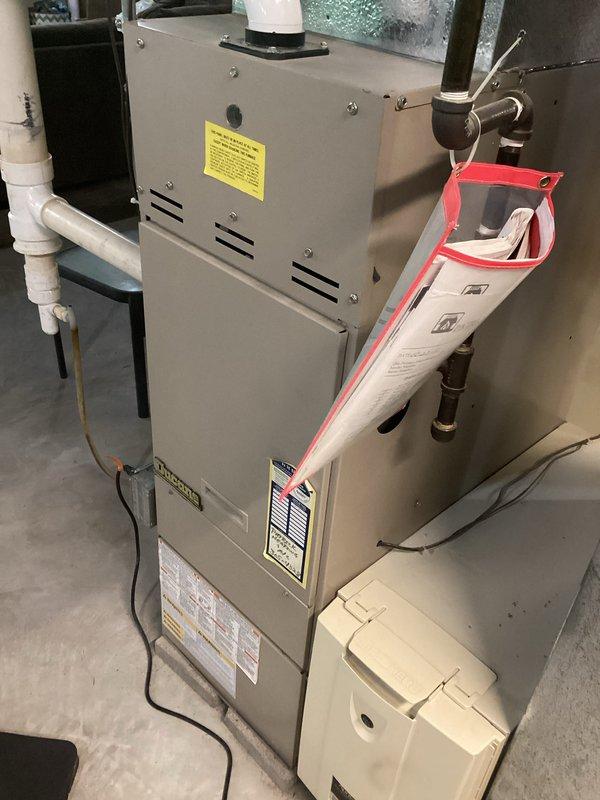 Responded to no heating and cooling call on aging HVAC system with reported previous power surge. Upon inspection, accessed furnace control board and found dual circuit boards with multiple electrical connections intact but verified system functionality after suspected electrical event. Documented equipment condition including condensate drainage system, gas connections, and control board components showing various indicator lights and terminal connections, confirming all wiring harnesses and safety controls were properly seated and operational.