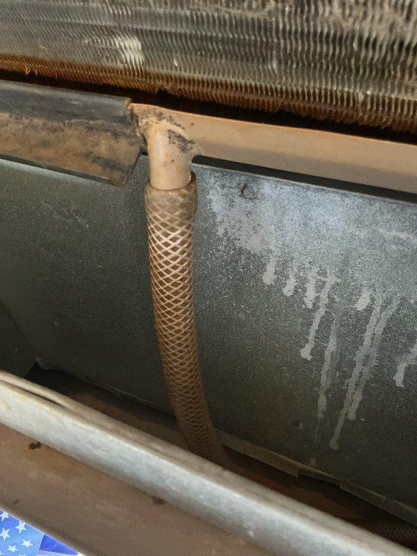 Responded to emergency call for AC unit leaking water into ceiling of unit below. Upon arrival, shut down system to prevent further water damage. Inspection revealed significant mold growth on ceiling surfaces in mechanical space, indicating prolonged moisture intrusion from condensate leak. Examined evaporator coil assembly and refrigerant lines, noting dust accumulation and potential drainage issues. Documented extensive water damage and mold contamination requiring immediate attention and remediation before unit can be safely returned to service.
