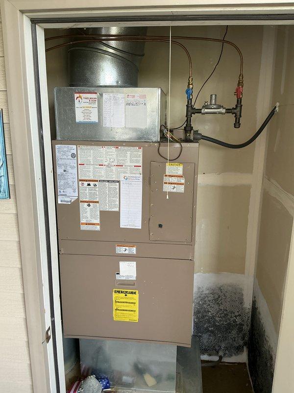Responded to emergency service call for Magicpak HVAC system evaluation. Conducted comprehensive assessment of existing unit (Model 51UWC243A-2A) installed in utility closet, documenting current equipment condition including refrigerant lines with service valves, ductwork plenum, and overall system configuration. Noted significant environmental concerns including visible microbial growth on adjacent wall surfaces and moisture accumulation on nearby window, indicating potential humidity control issues. Prepared complete replacement estimate for customer review, photographing existing installation specifications, manufacturer labels, and EnergyGuide ratings to ensure accurate equipment sizing and proper system replacement planning.