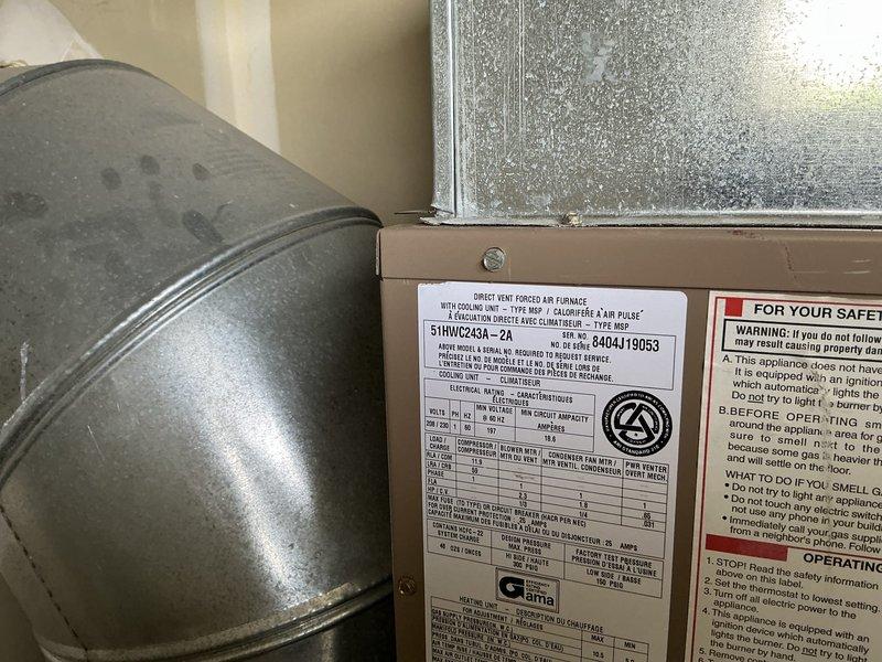 Responded to emergency service call for Magicpak HVAC system evaluation. Conducted comprehensive assessment of existing unit (Model 51UWC243A-2A) installed in utility closet, documenting current equipment condition including refrigerant lines with service valves, ductwork plenum, and overall system configuration. Noted significant environmental concerns including visible microbial growth on adjacent wall surfaces and moisture accumulation on nearby window, indicating potential humidity control issues. Prepared complete replacement estimate for customer review, photographing existing installation specifications, manufacturer labels, and EnergyGuide ratings to ensure accurate equipment sizing and proper system replacement planning.