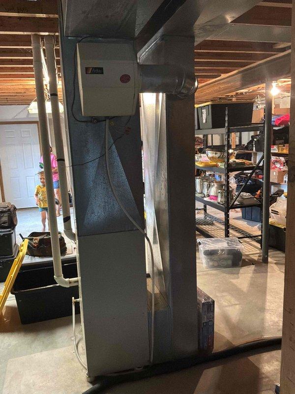 Conducted comprehensive duct cleaning estimate for residential HVAC system featuring vertical air handler unit with flexible ductwork connections in basement utility area. Assessed accessible ductwork, air handler cabinet, and adjacent furnace system with copper piping to determine scope of cleaning services required for optimal system performance and indoor air quality improvement.