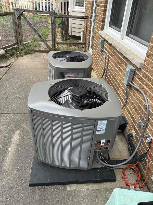 Provided estimate for disconnecting and reconnecting two outdoor condenser units to accommodate new patio installation. The dual-unit system, currently installed on a concrete pad along the brick exterior, will require temporary disconnection of refrigerant lines, electrical connections, and condensate drainage during the patio construction process, with full reconnection and system testing upon completion of the concrete work expected to take approximately five days.