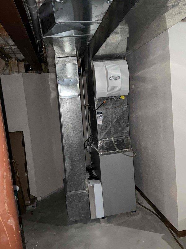 Completed comprehensive HVAC system replacement estimate for residential basement installation. Assessed existing furnace, air handler, Aprilaire humidifier, and ductwork configuration in unfinished basement mechanical room. Documented current equipment layout including vertical plenum assembly, supply and return ductwork, PVC condensate drainage, and electrical connections to provide accurate replacement specifications and system upgrade recommendations.