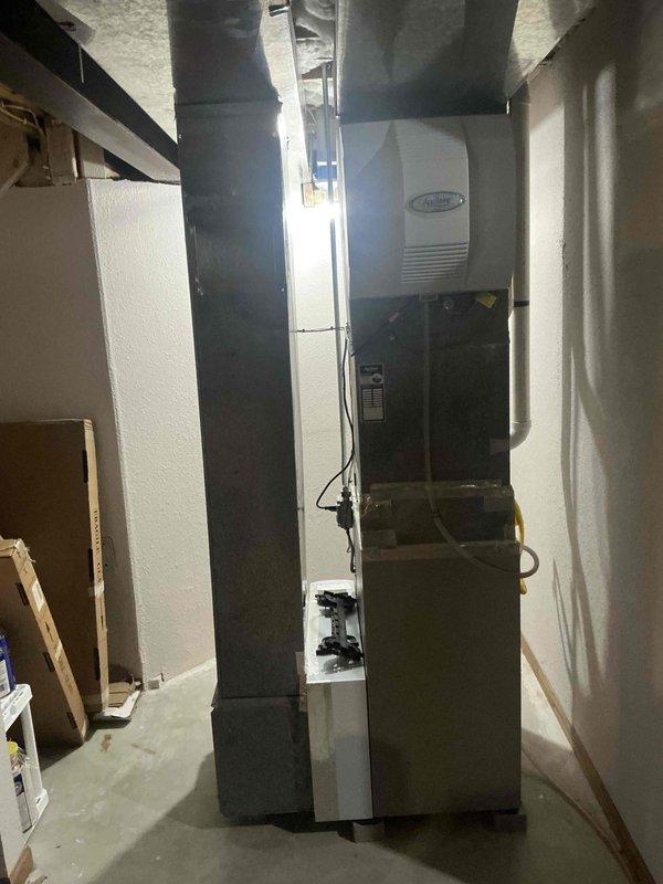Completed comprehensive HVAC system replacement estimate for residential basement installation. Assessed existing furnace, air handler, Aprilaire humidifier, and ductwork configuration in unfinished basement mechanical room. Documented current equipment layout including vertical plenum assembly, supply and return ductwork, PVC condensate drainage, and electrical connections to provide accurate replacement specifications and system upgrade recommendations.