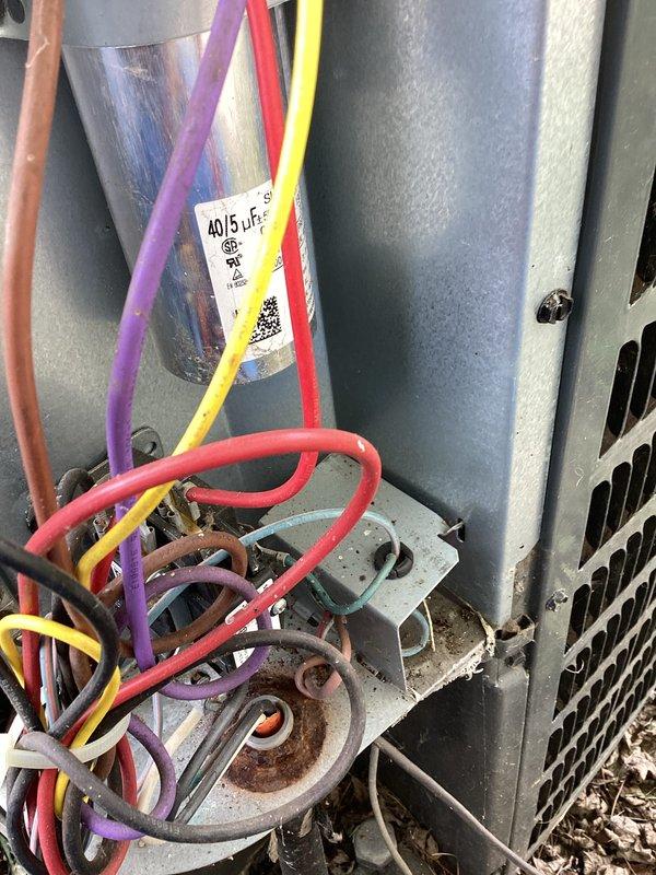 Completed comprehensive A/C tune-up on residential cooling system. Inspected evaporator coil and found moderate accumulation of dust and debris on fins, which was noted for maintenance tracking. Verified electrical connections at outdoor unit, including dual-run capacitor (40/5 µF) and associated wiring terminals, confirming all connections were secure and operational. System tested and running within normal parameters.