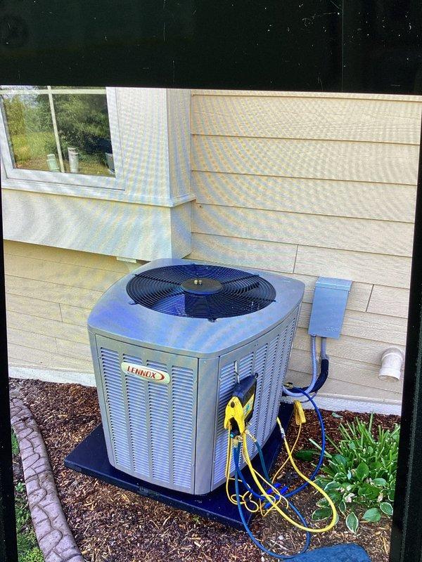 Performed standard air conditioning tune-up on residential Lennox condenser unit. Connected manifold gauges to measure system pressures, recording 116.9 psig on low side and 223.4 psig on high side for R-410A refrigerant. System operating within normal parameters with acceptable superheat and subcooling readings.
