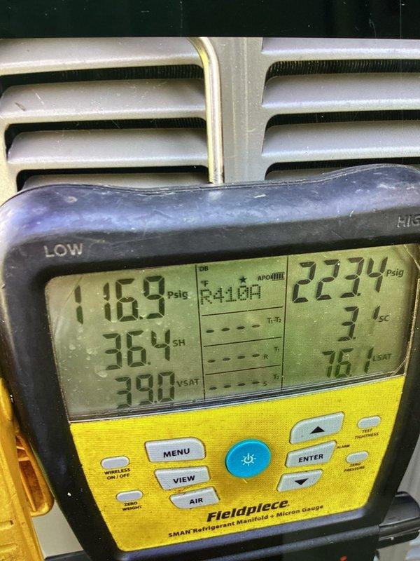 Performed standard air conditioning tune-up on residential Lennox condenser unit. Connected manifold gauges to measure system pressures, recording 116.9 psig on low side and 223.4 psig on high side for R-410A refrigerant. System operating within normal parameters with acceptable superheat and subcooling readings.