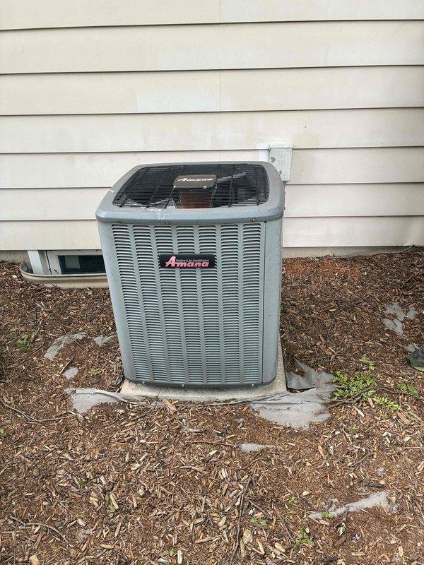 Performed comprehensive assessment of non-cooling Amana air conditioning system experiencing refrigerant loss and evaporator coil icing. Documented existing outdoor condenser unit condition and electrical panel configuration, then provided detailed replacement estimate with financing options for complete system upgrade due to refrigerant leak and compromised cooling performance.