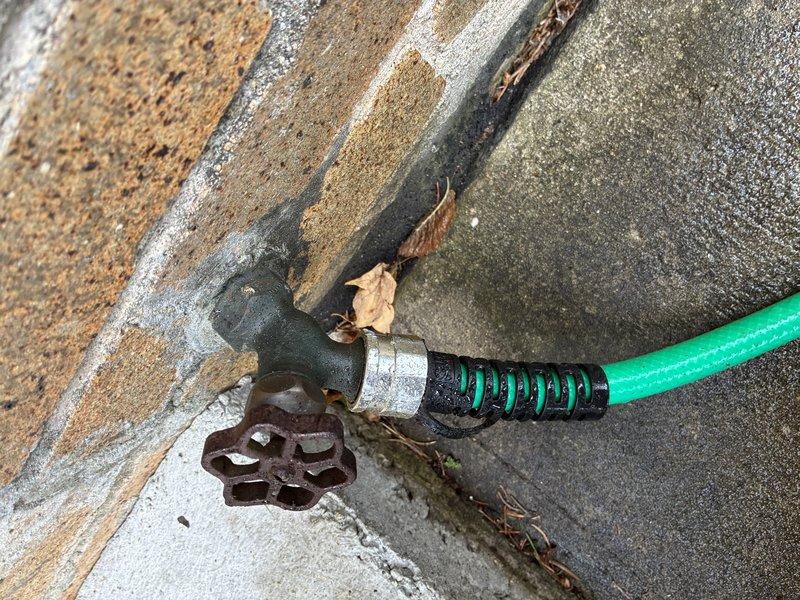 Responded to service call for outdoor hose bibb with stuck garden hose coupling. Successfully removed seized metal hose connector from the spigot threads and restored proper function to the exterior water fixture. The hose connection was freed without damage to the spigot or garden hose, allowing for normal operation and future hose attachment and removal.