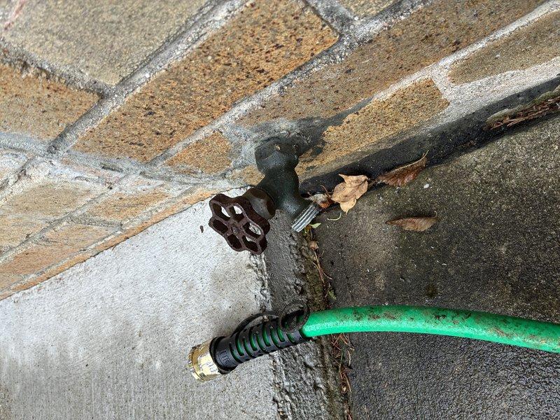 Responded to service call for outdoor hose bibb with stuck garden hose coupling. Successfully removed seized metal hose connector from the spigot threads and restored proper function to the exterior water fixture. The hose connection was freed without damage to the spigot or garden hose, allowing for normal operation and future hose attachment and removal.