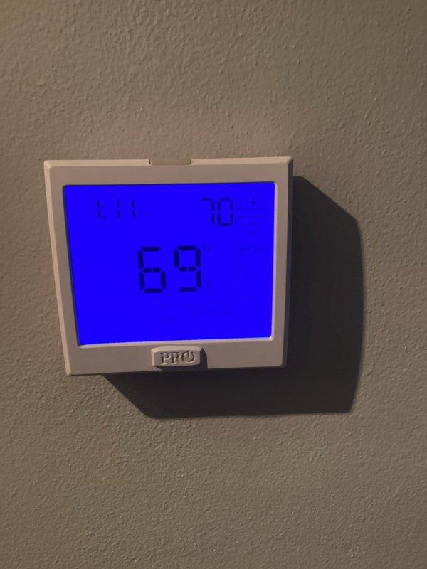 Responded to complaint of air conditioning unit continuing to run after reaching set temperature. Inspected thermostat operation and found temperature differential settings required adjustment. Verified thermostat displaying 69°F and confirmed proper communication with outdoor condensing unit. Adjusted anticipator settings to reduce runtime after temperature satisfaction. System tested and cycling properly at completion.