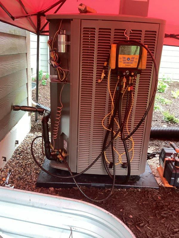 Completed full HVAC system installation including new furnace, air conditioning unit, S40 thermostat, F100 media air cleaner, return platform, and Patriot condensate pump. Coordinated with electrician for proper electrical connections and obtained all necessary permits prior to installation. Installed outdoor condensing unit on concrete pad with proper refrigerant line routing and insulation, mounted new furnace with integrated return air platform in mechanical space, and installed PVC condensate drainage system with vertical discharge pipe secured to exterior siding. Commissioned system with complete startup procedures, verified proper refrigerant charge and pressures using digital manifold gauges, confirmed electrical connections meet code requirements, and tested all system components for proper operation including airflow, temperature differential, and safety controls.