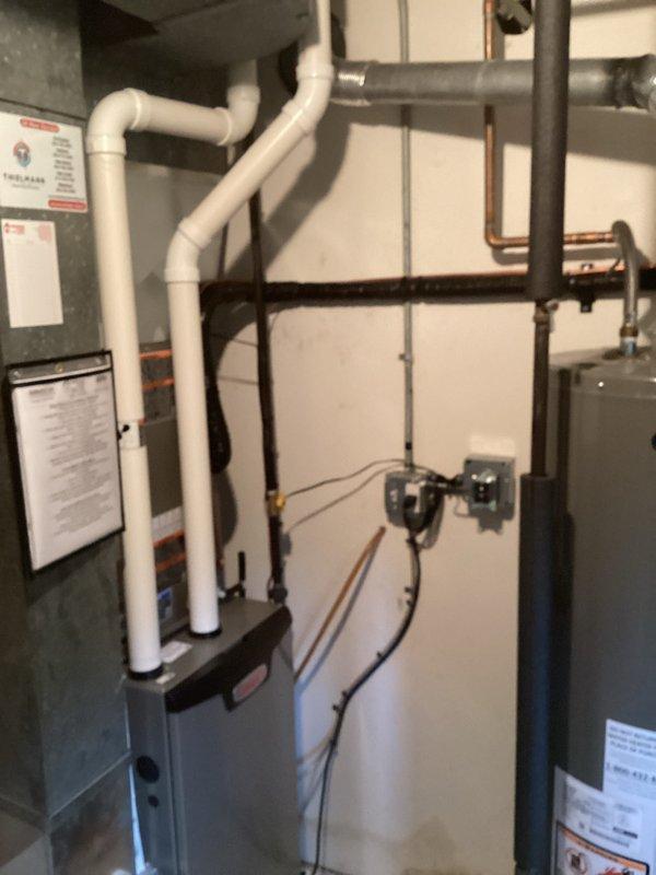 # HVAC System Installation

Completed full residential HVAC system installation including new furnace and air conditioning unit. Installed gray furnace with proper white PVC venting routed vertically through structure for exhaust and condensate drainage. Configured all electrical connections and mounted manufacturer documentation on unit exterior panel.

Performed complete air conditioning installation with refrigerant line connections using brass fittings. Evacuated refrigeration system to proper vacuum levels, achieving 188 microns as verified with calibrated digital vacuum gauge. Held vacuum to manufacturer specifications to ensure system integrity and removal of moisture and non-condensables from refrigerant lines.

Connected all necessary piping including black iron gas lines and integrated system with existing water heating equipment. Installed circulation pump on hydronic piping with proper orientation and connections. Routed copper and iron piping between components following c