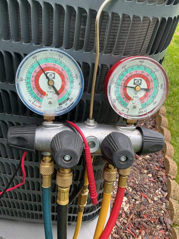 Performed comprehensive cooling system tune-up and maintenance inspection on outdoor air conditioning unit as part of recurring membership agreement. Connected manifold gauges to measure system pressures and verify proper refrigerant charge levels, with readings indicating normal operating parameters across both high and low-side pressures. Utilized digital multimeter to test electrical components, measuring capacitance at 35.66 MFD and verifying proper voltage and amperage at contactor and compressor terminals. All electrical connections were inspected and found secure, with no signs of overheating or deterioration. System operational testing confirmed unit is cooling efficiently and operating within manufacturer specifications.